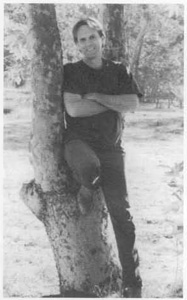 A photo of John H. Ritter standing beside a tree