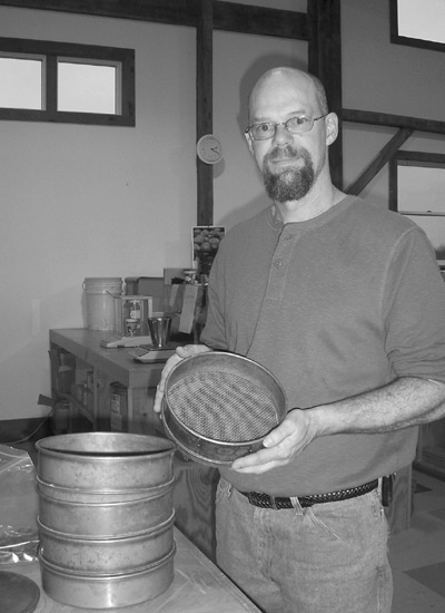 Joe Inman with sieves for 
separating seed from chaff.