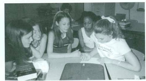 students at a table in discussion
