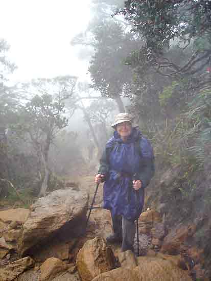 Figure 7. The author descending
at about 2700 m on the Summit Trail in rain and cloud.