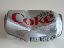 A photo of a crushed coke can.