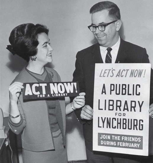 1960's era man woman displaying Library Action posters.